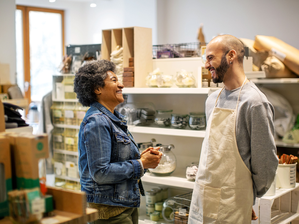 Two people happily chat in a studio.