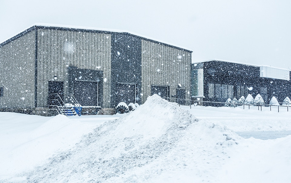 Snow falling on commercial building.