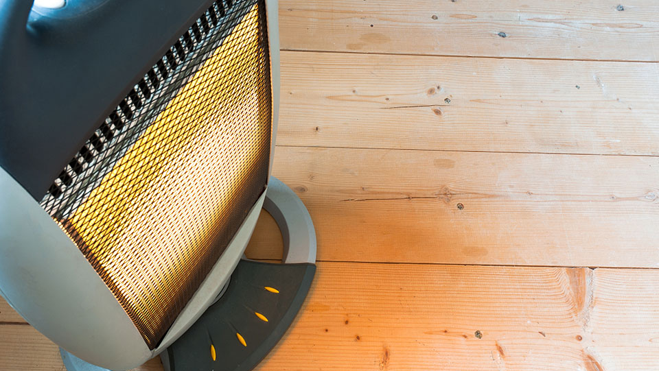 Space heater safely glowing on floor.