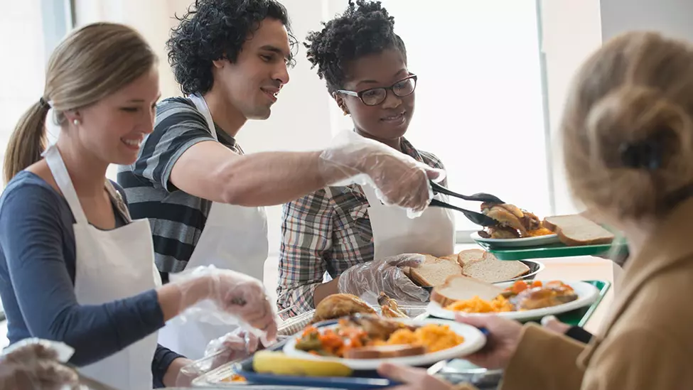 Students serving food on campus.