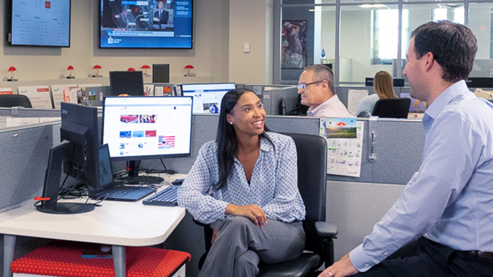 Man and woman talking in an office.