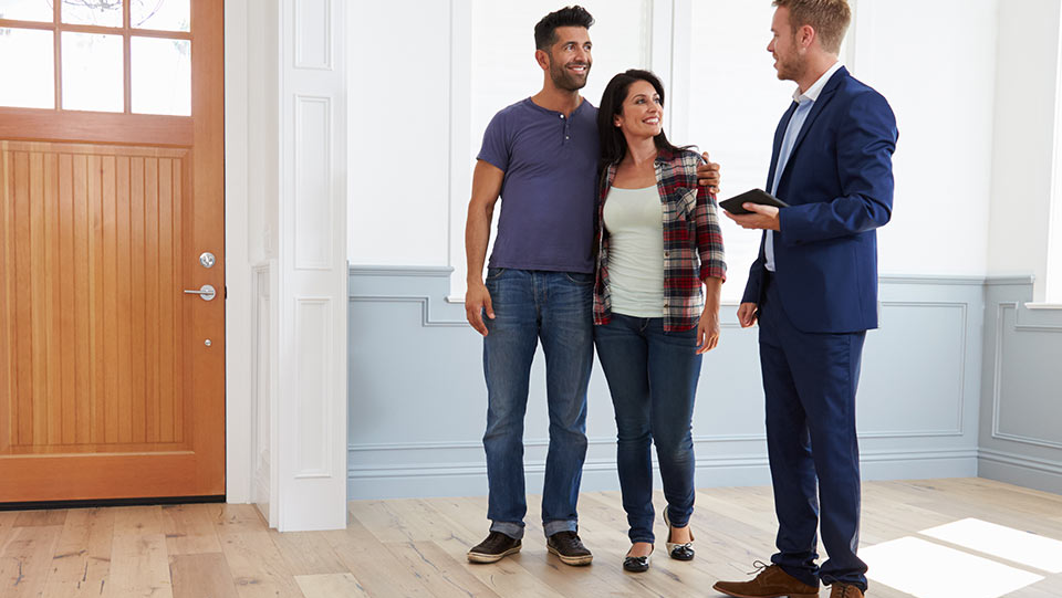 Couple of new homeowners looking at an empty house.