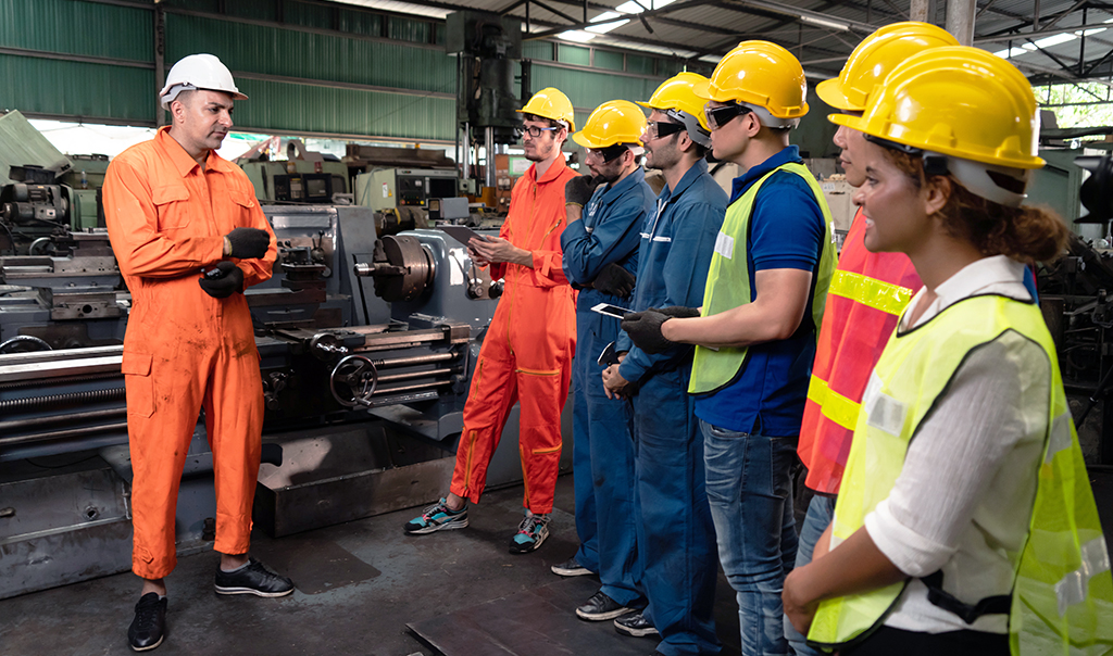 Factory workers having a meeting on the floor.