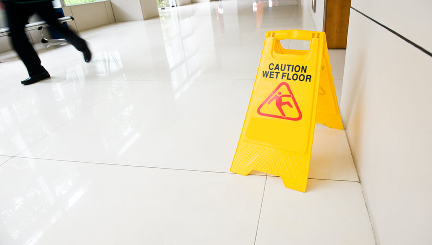 Yellow caution wet floor sign in a hallway