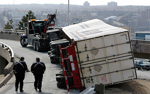 Tow truck with overturned truck