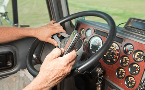 Truck driver scrolling mobile device