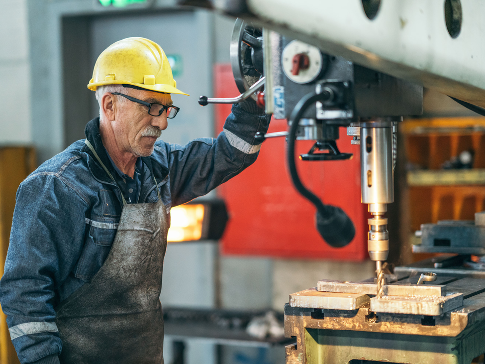 Gentleman works at a machine shop manufacturing parts for the oil and gas industry.