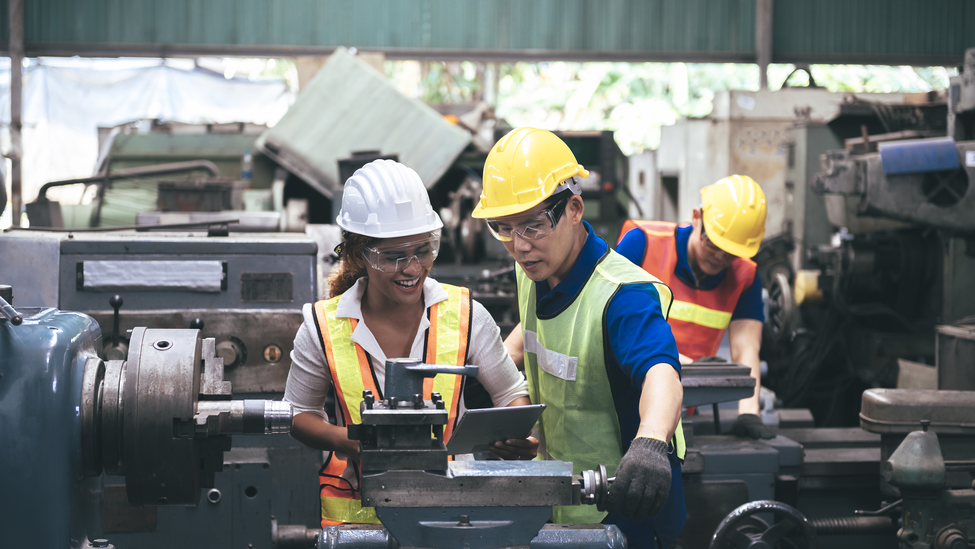 two assembly line workers at a manufacturing plant