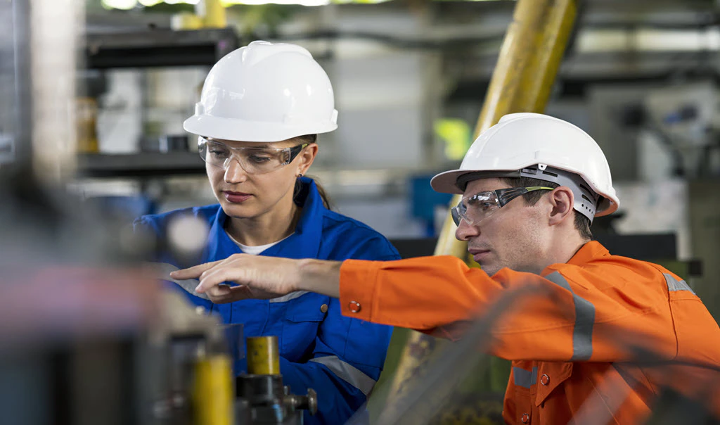 Two manufacturing employees working together.