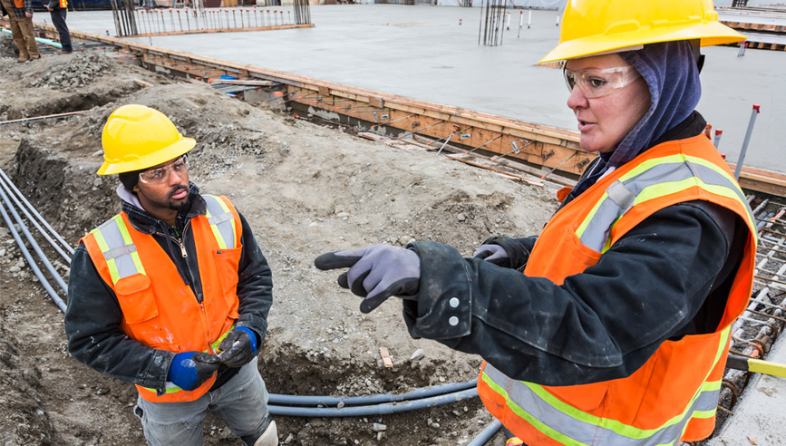 Utility contractors working on construction site.