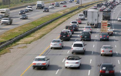 View of cars and trucks driving down interstate