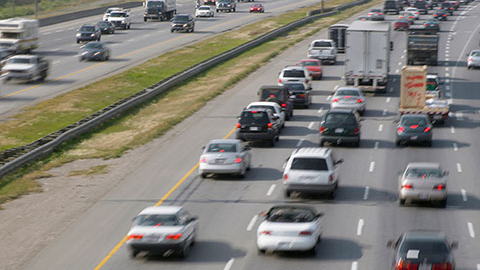 View of cars and trucks driving down interstate