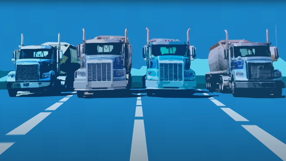  View of four trucks lined side by side in parking lot