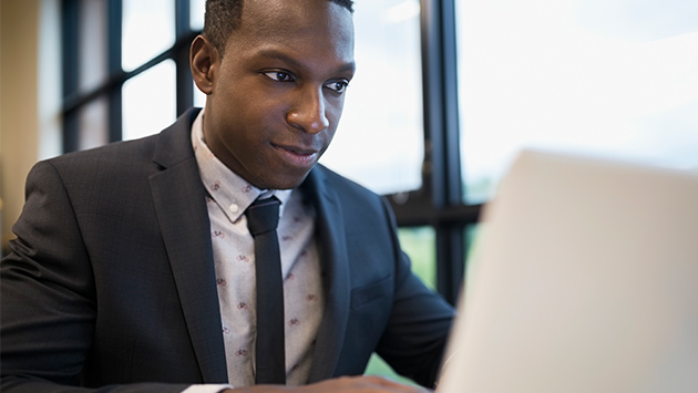 A professional working in front of the laptop.