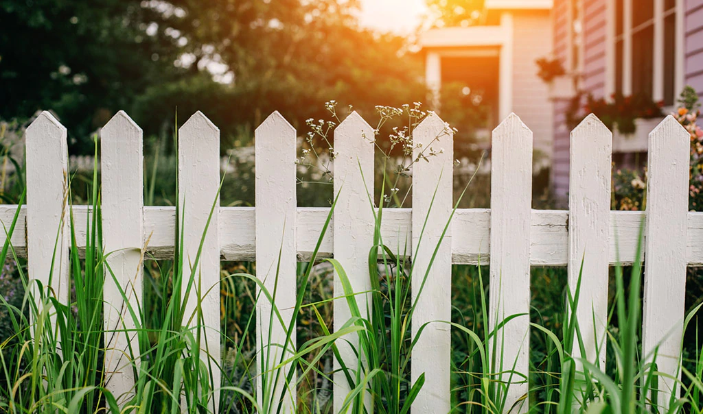 White picket fence next to house.