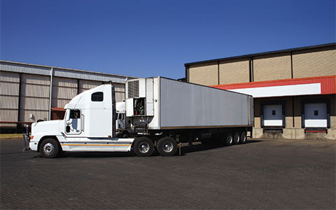 White truck in parking lot making a left turn