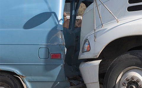 White truck rear ends blue van