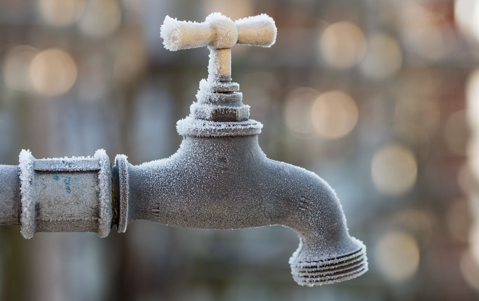 Faucet showing signs of frost on a cold morning