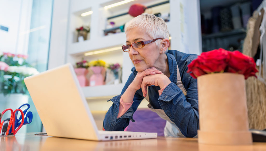 Woman looking at the laptop.