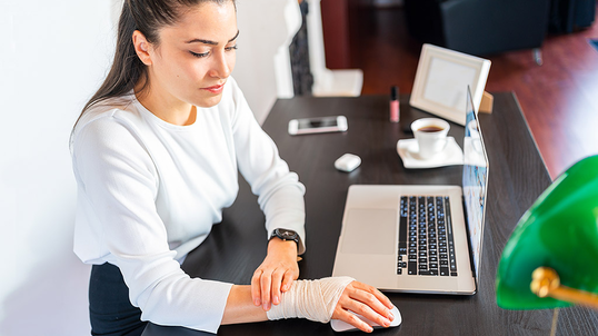 woman-at-desk-with-bandaged-arm-large.jpg