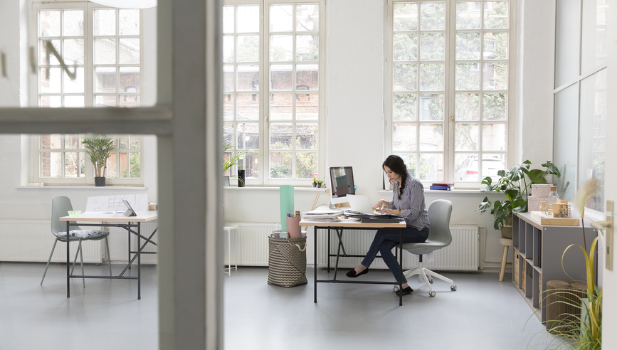 Woman working at desk in a loft office