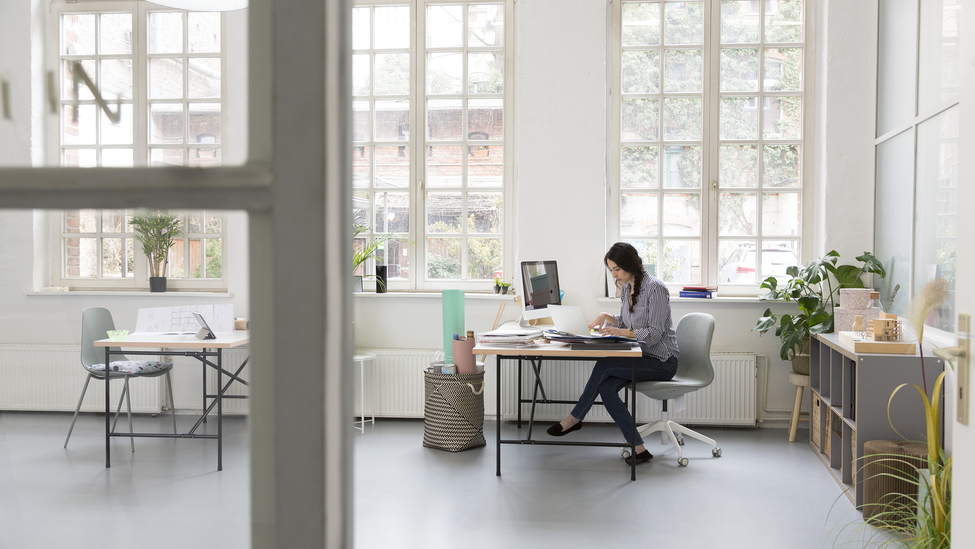 Woman working at desk in a loft office