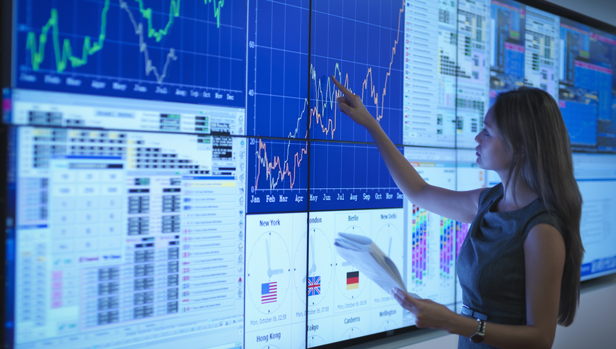 Businesswoman preparing presentation on graphical screens