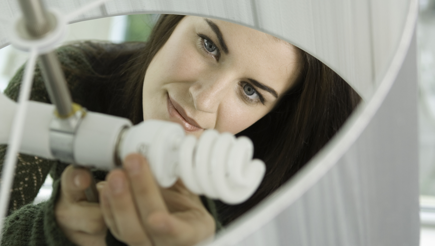 Woman installing new lightbulb 