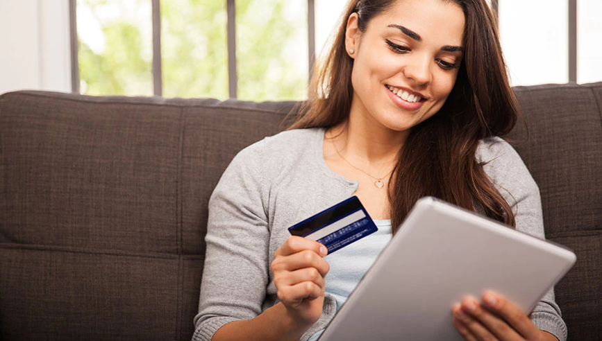 Woman making an online purchase and practicing online identity theft prevention.