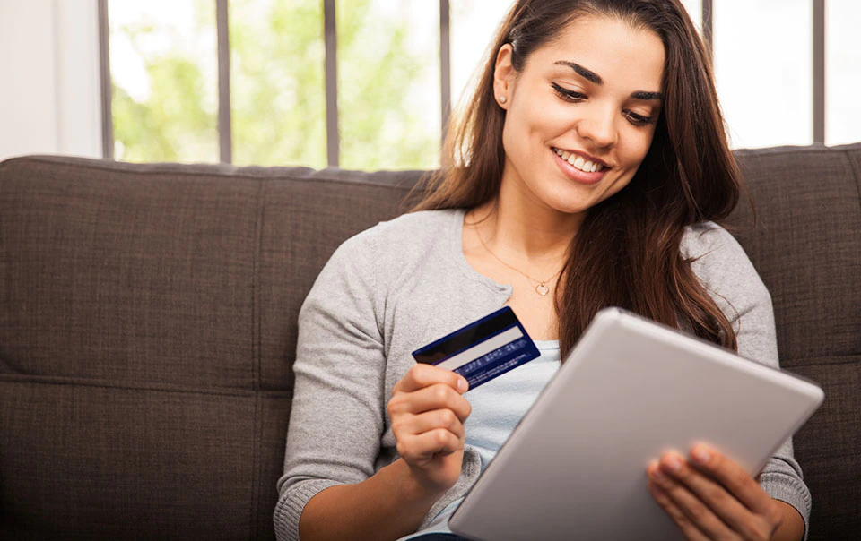 Woman making an online purchase and practicing online identity theft prevention.