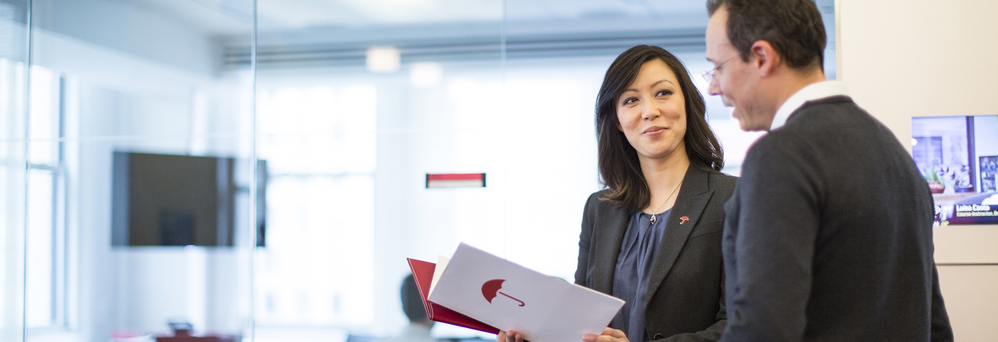 Woman in light-filled room holding Travelers brochure.