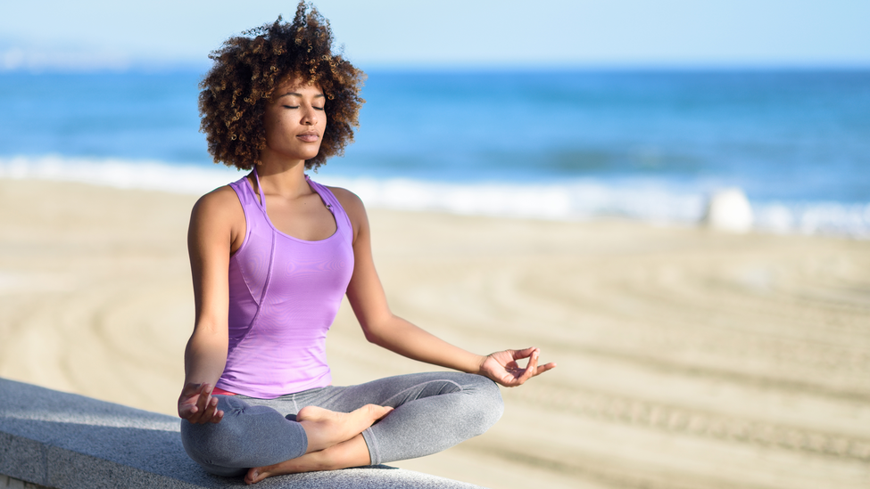 woman-meditates-on-calm-beach.jpg