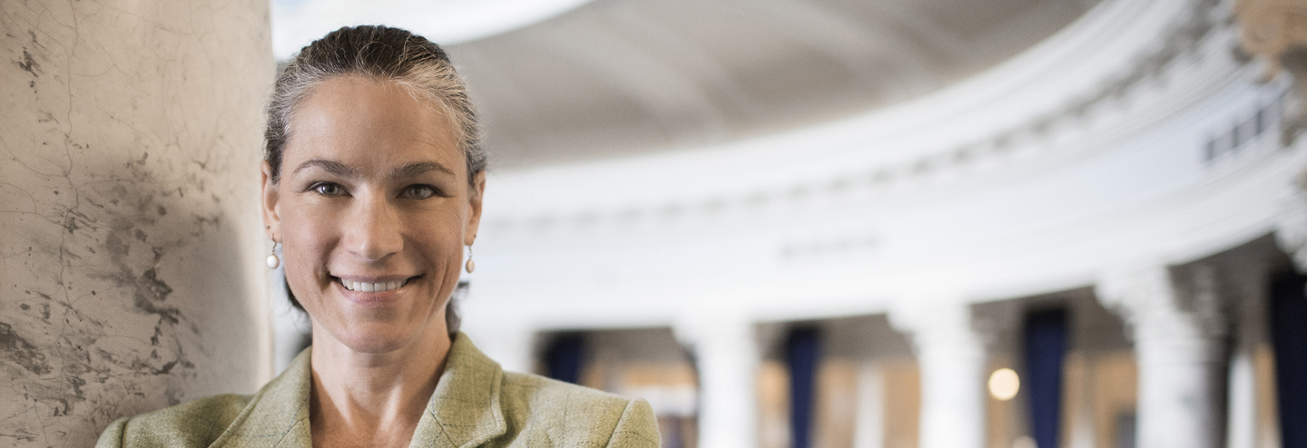 Leader smiling while standing inside a civic building.