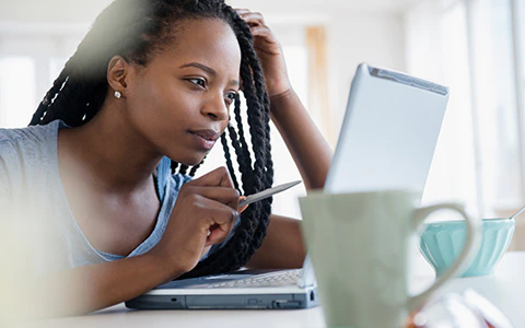 Woman researching how much homeowners insurance she needs.