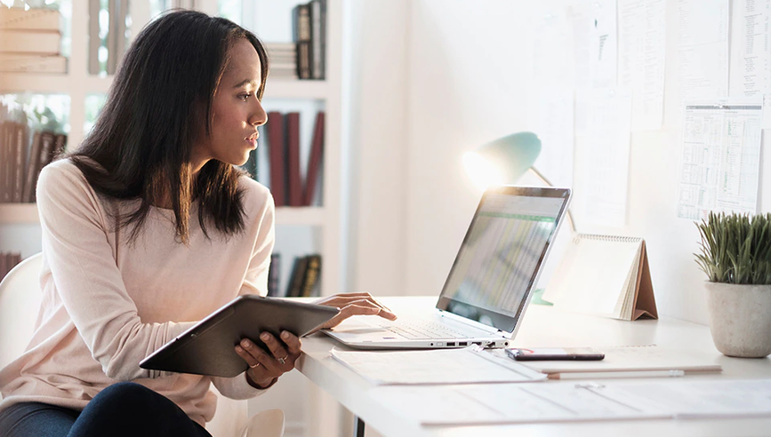 Woman sitting at home office in front of laptop.