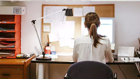 Woman sitting in a chair.