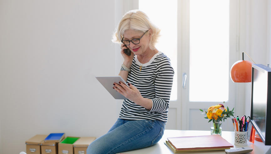 Women on phone looking at ipad