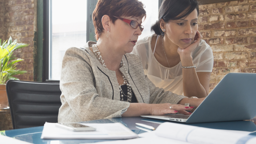 Businesswomen using laptop in office