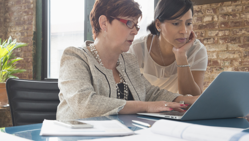 Businesswomen using laptop in office