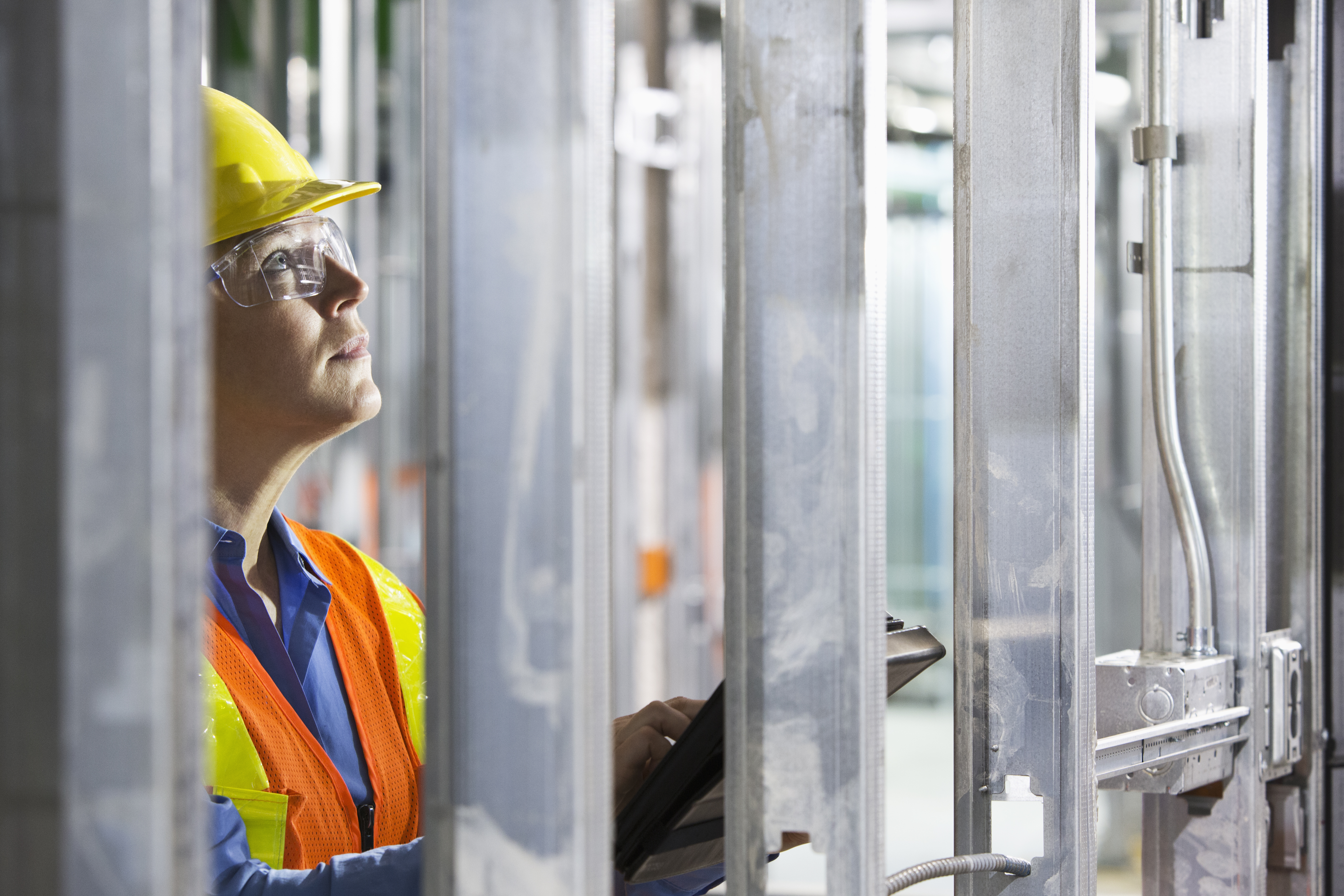 Worker surveying metal on site