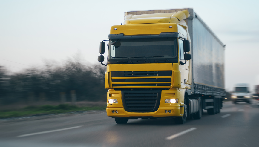 Large semi-truck driving down highway