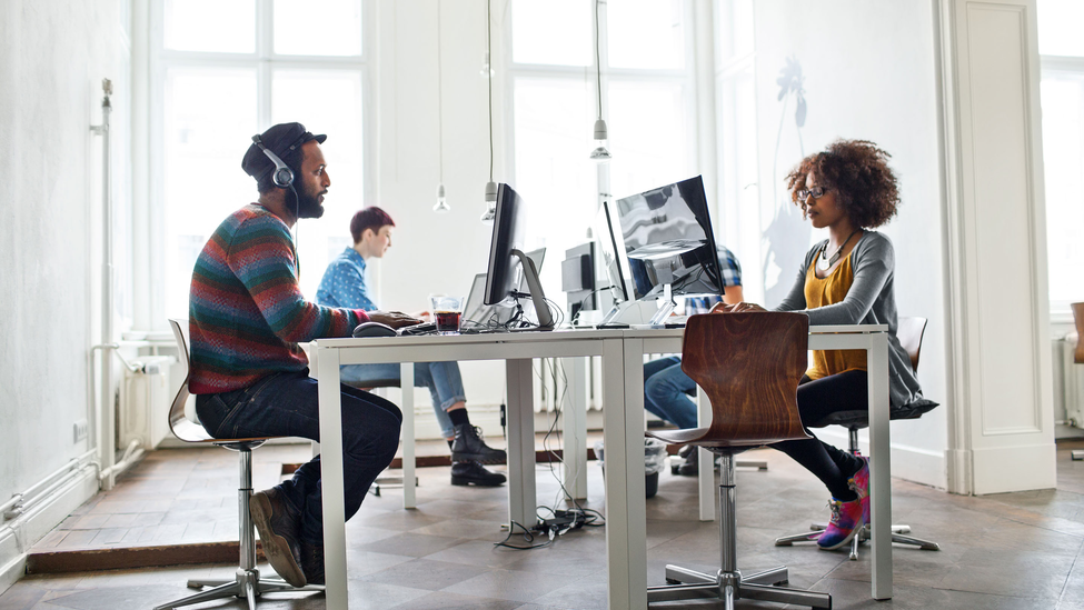 Young creative people working on computers at their desk