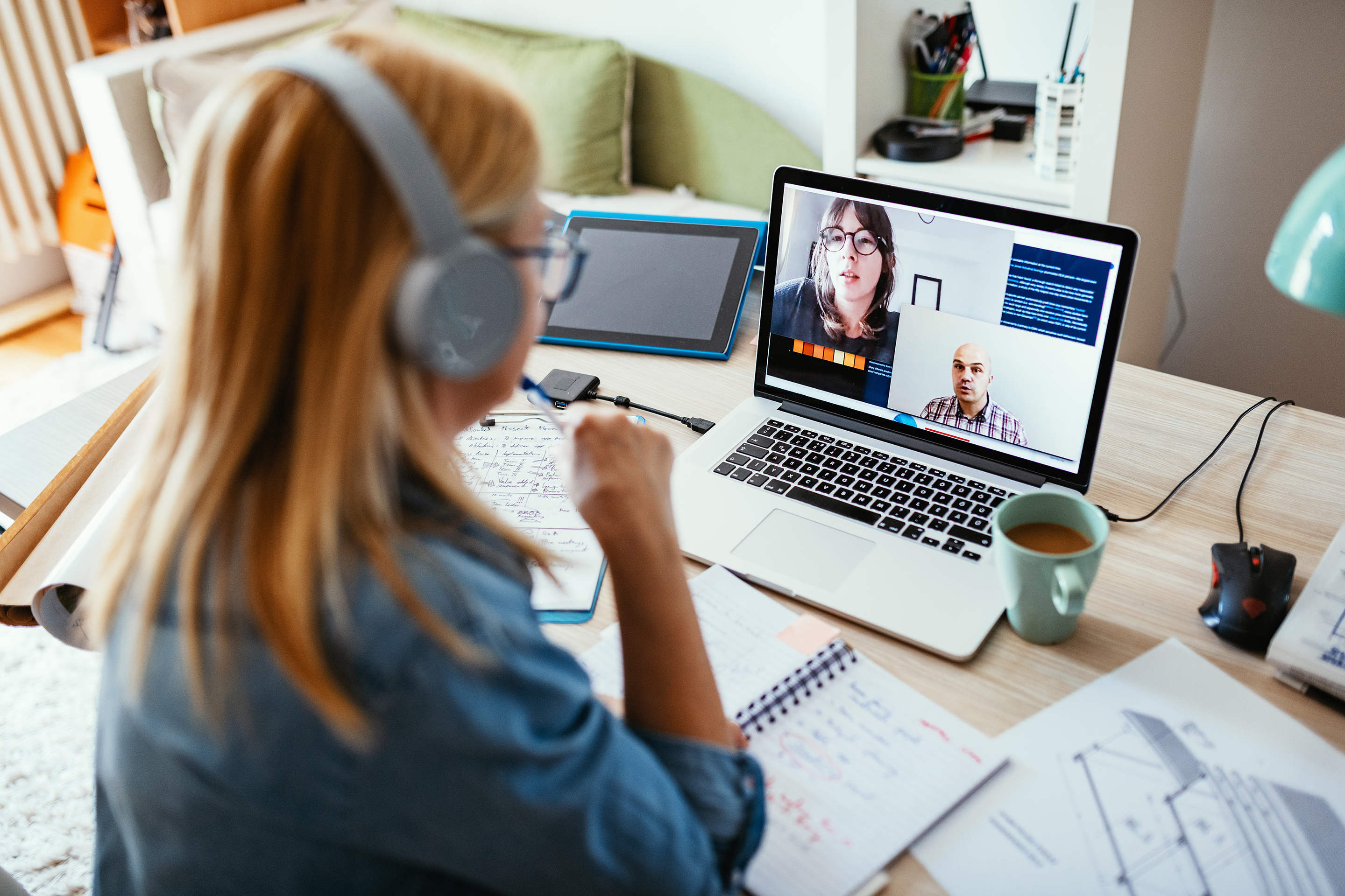 Young woman having a video conference on a laptop in her home office.